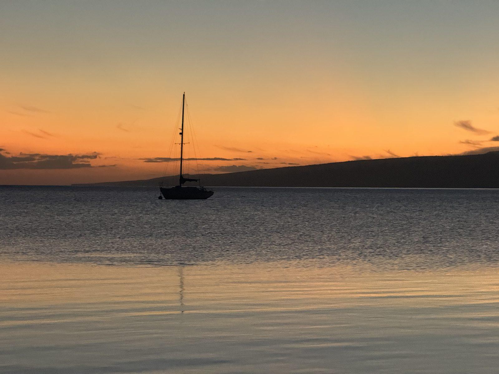 Peaceful sunset silhouette over calm waters
