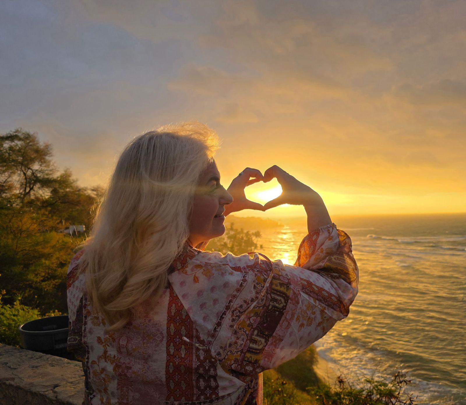 Making a heart over the sunrise at a Diamond Head lookout