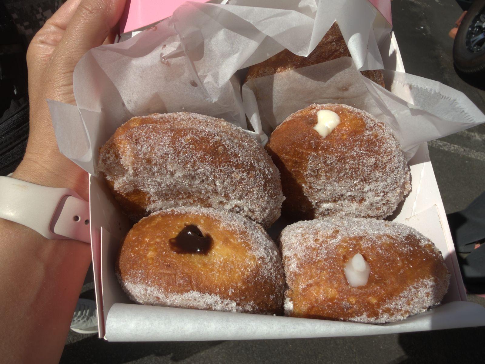 A box of fresh, filled malasadas from Leonard’s